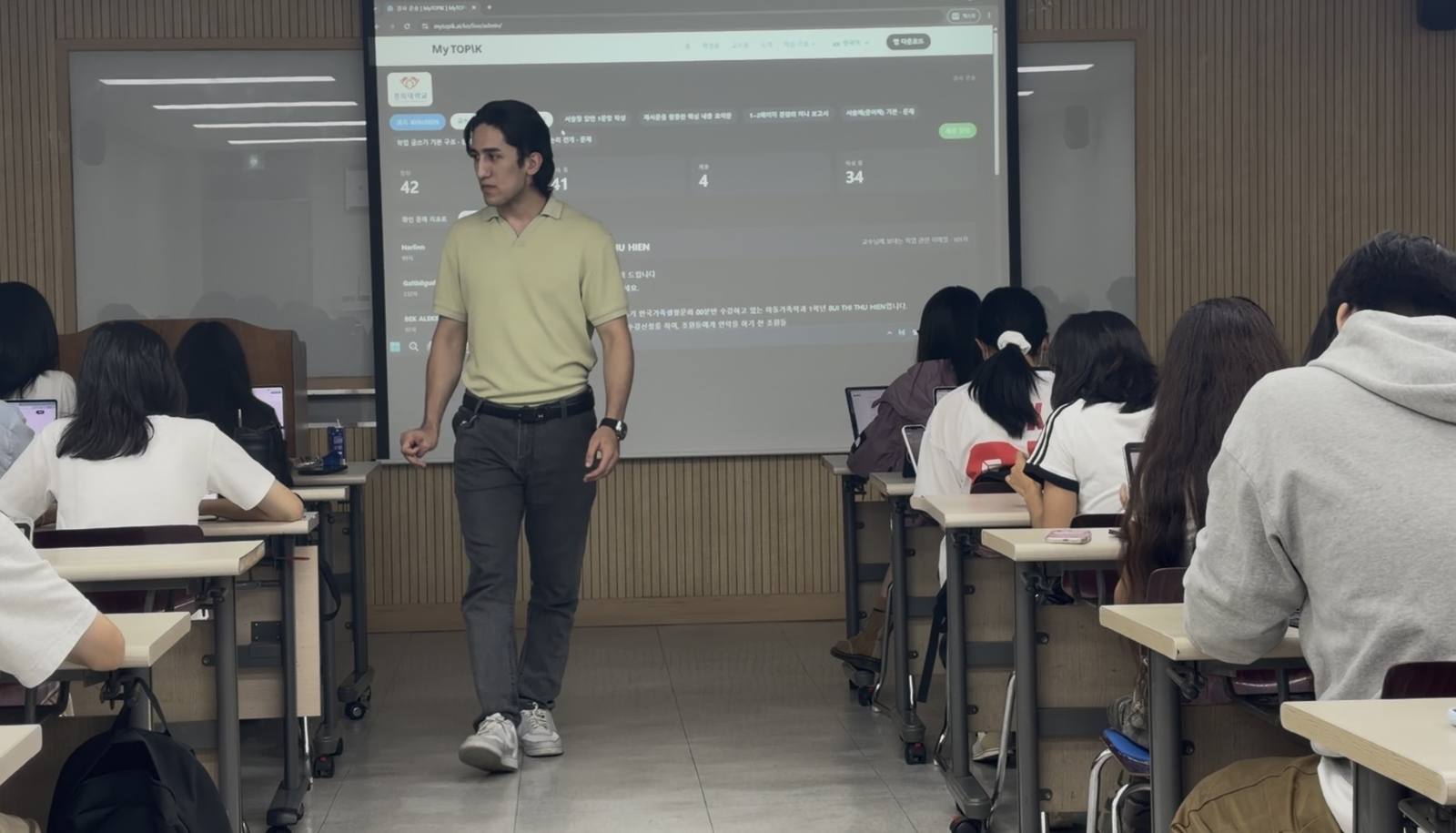 The lecturer reading a submitted email on the projected console